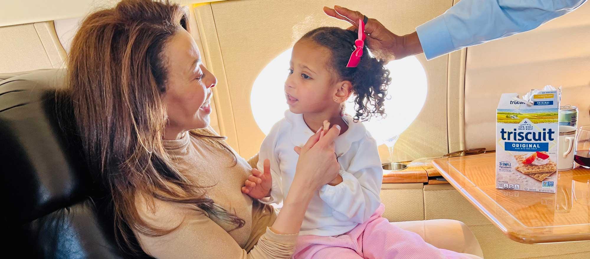 Lisa Simonsen on private jet with child