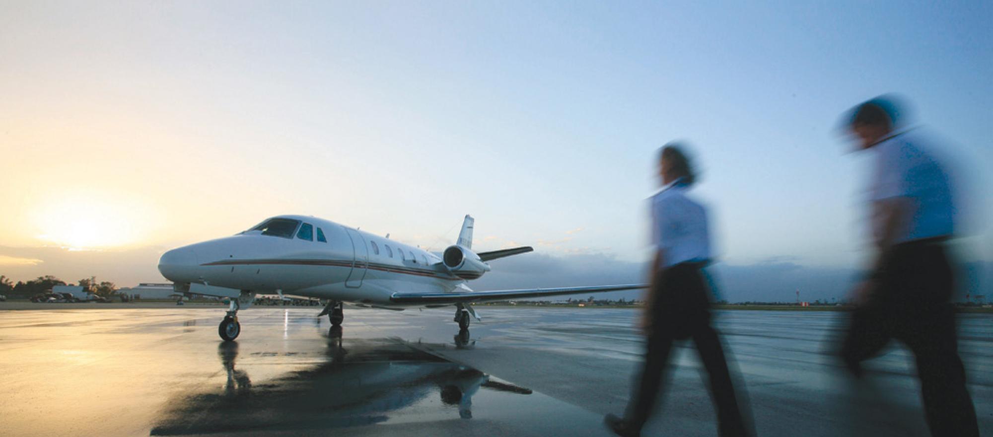 Two NetJets pilots walking out to their airplane.