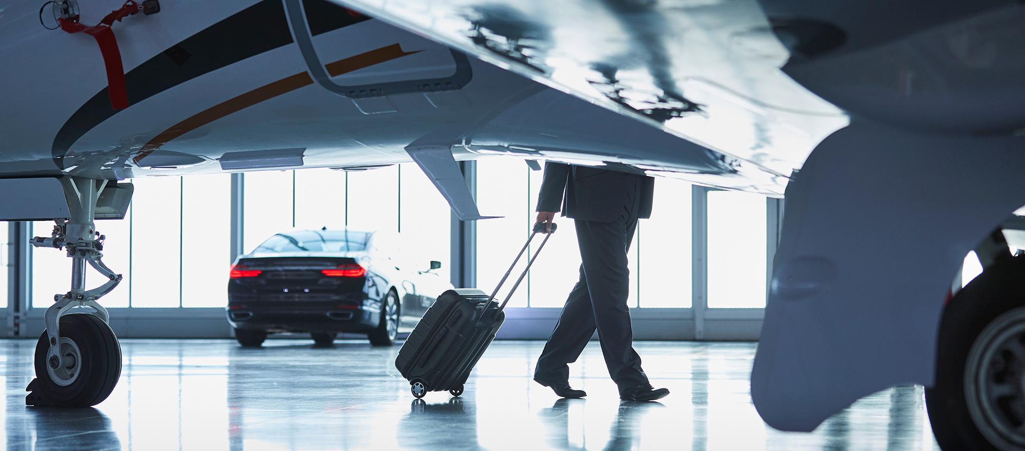business jet and man with suitcase