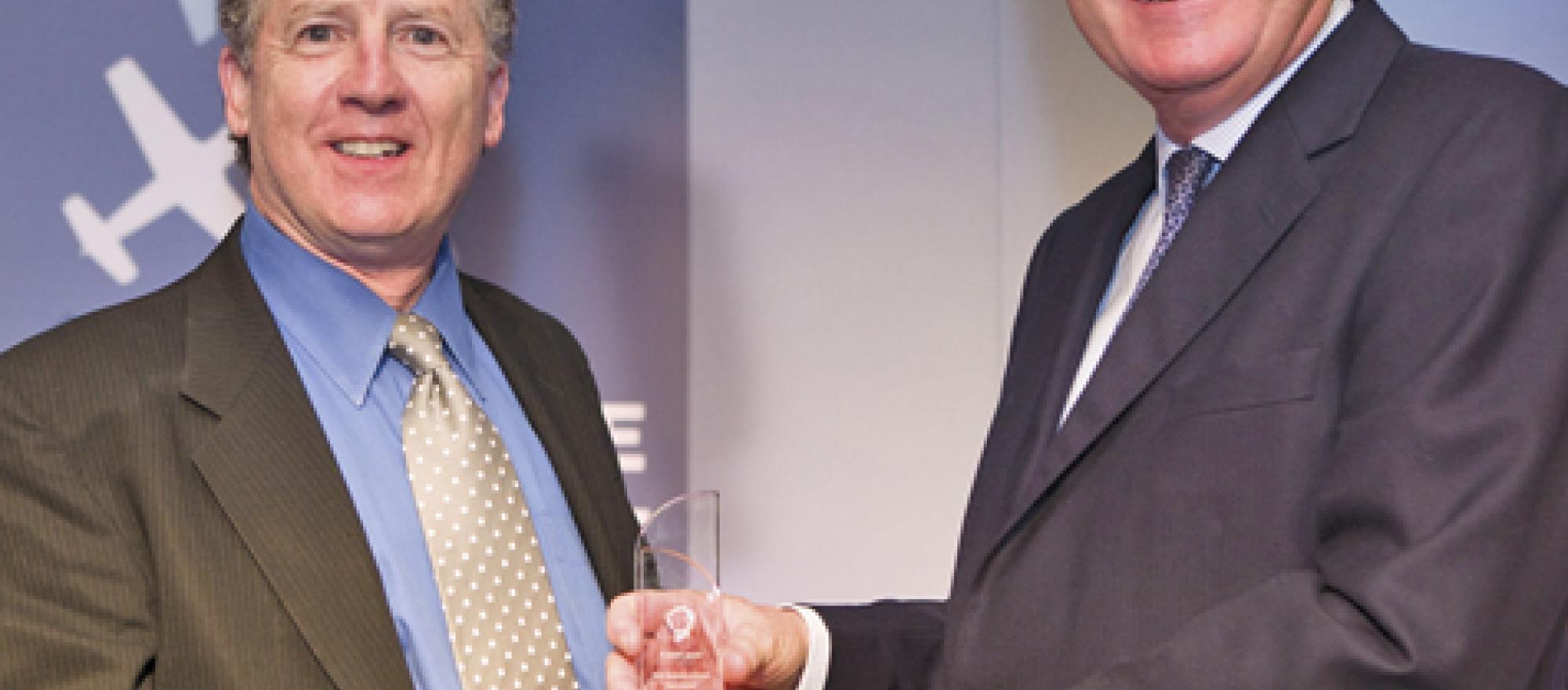 Robert Mark (left) receives his award in Paris from World leadership forum pr