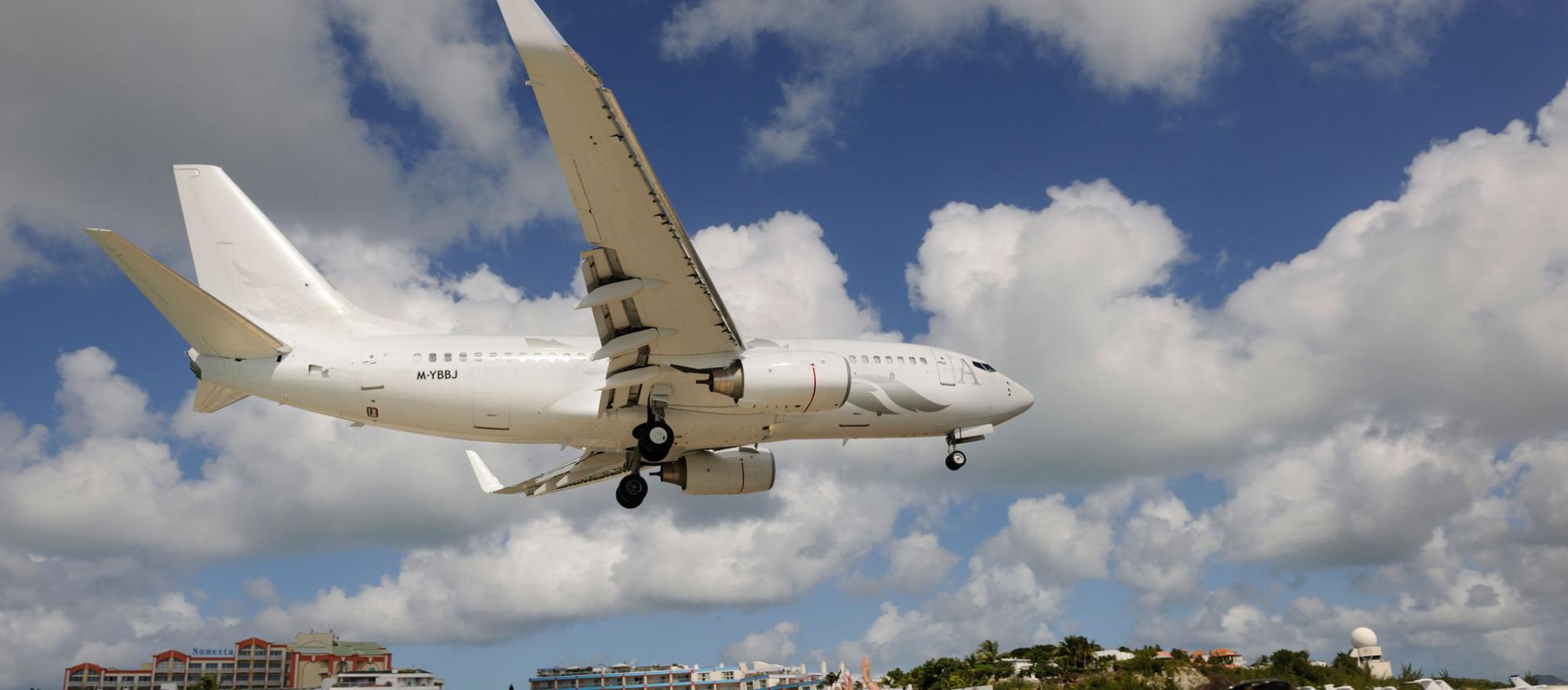 plane flying over beach