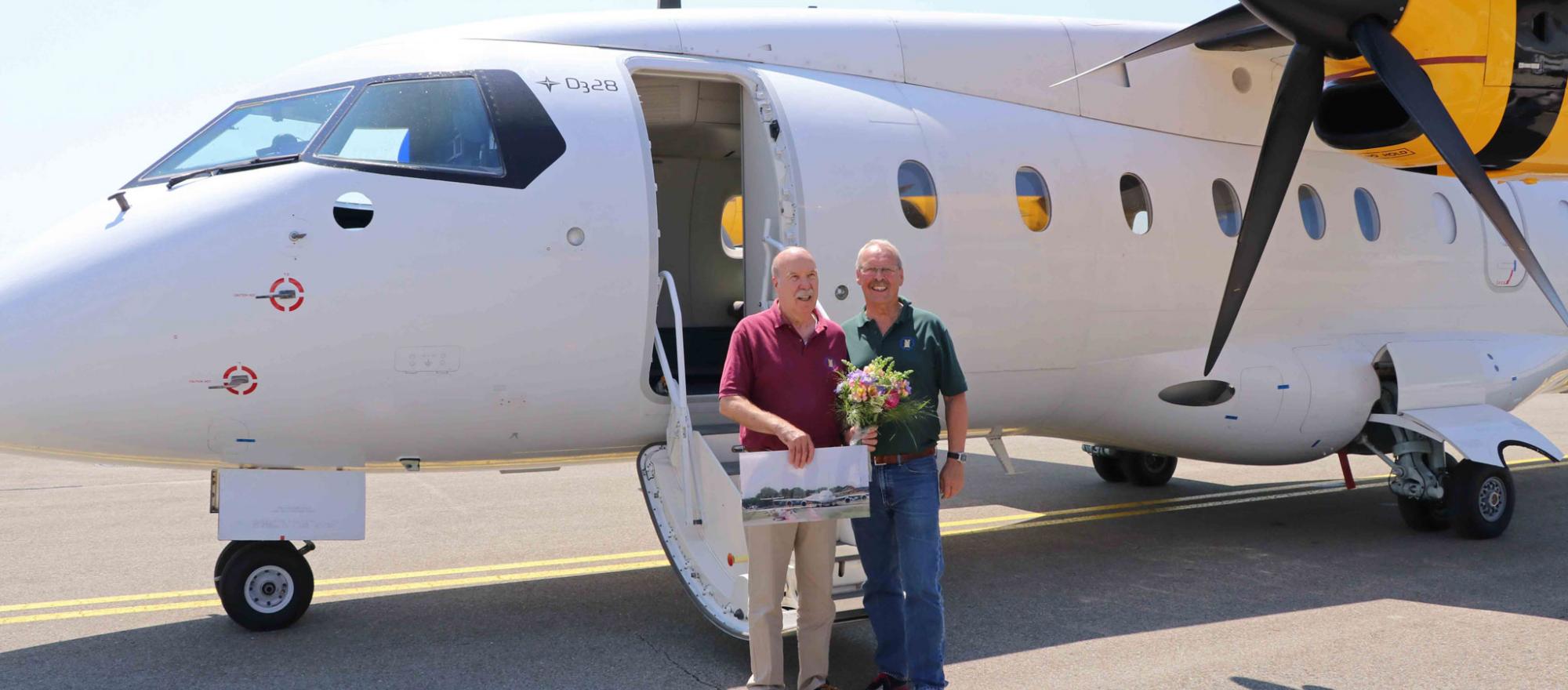 Weger and coworker near plane
