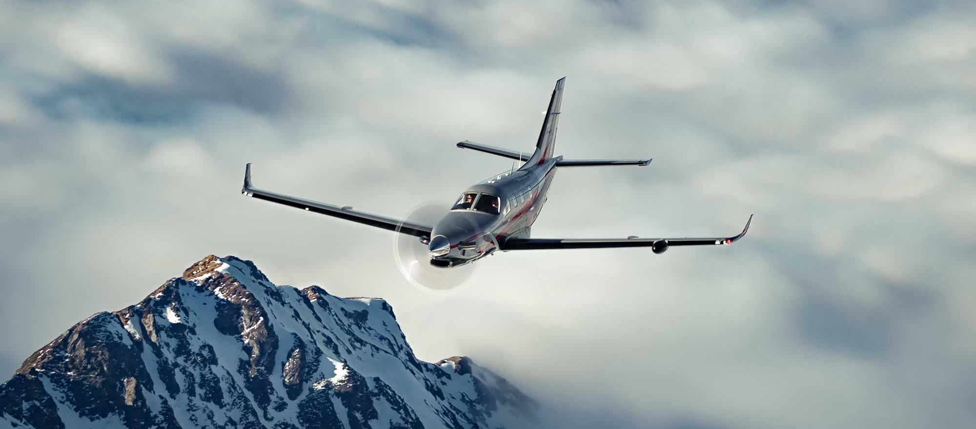 Daher TBM 960 in flight over snow capped mountains