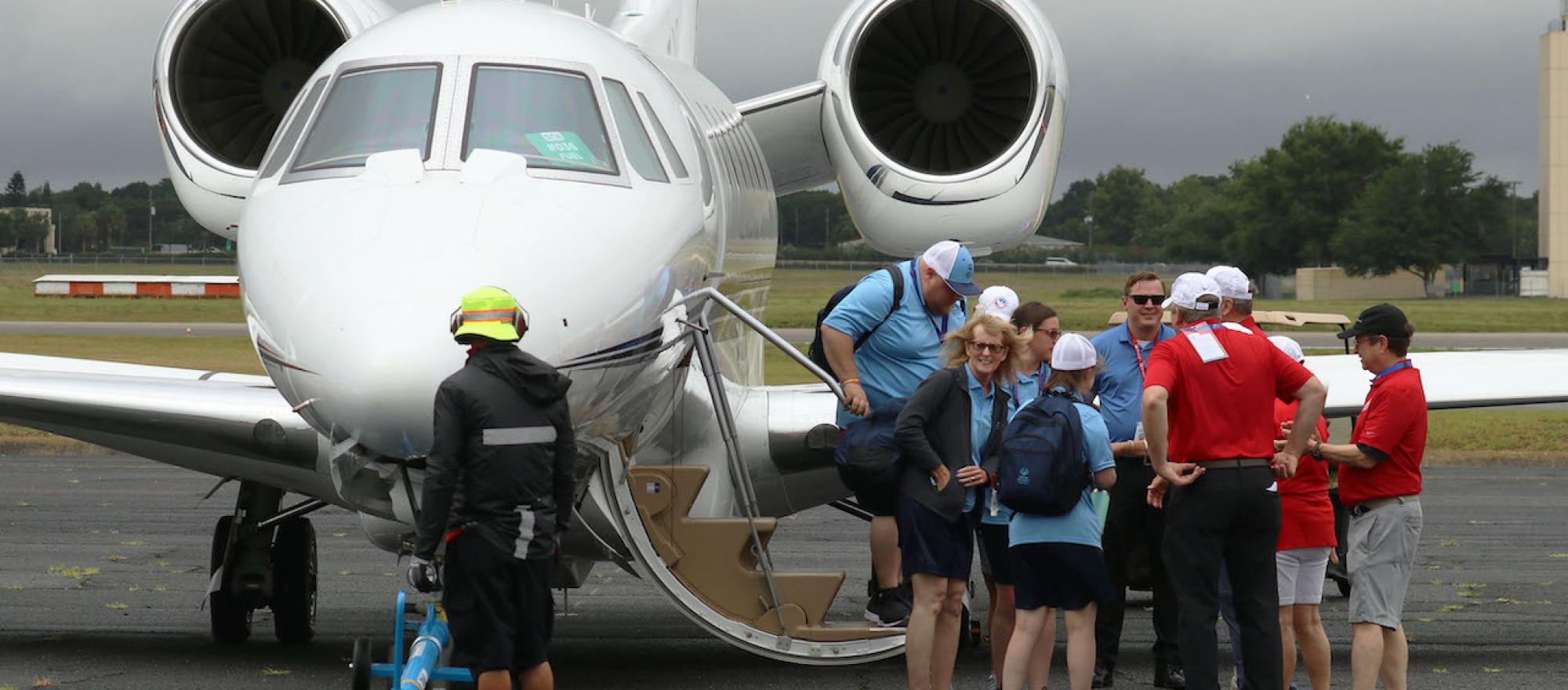 Special Olympics passengers disembark Cessna Citation X