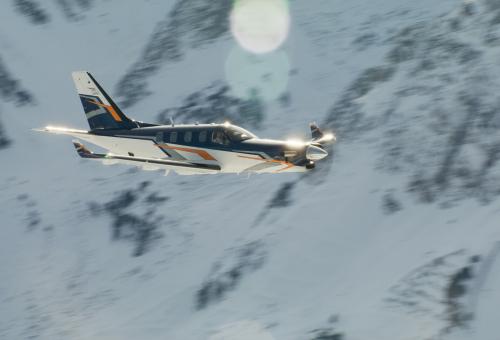 Daher TBM 980 flying beside mountain