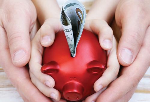 Hands holding piggy bank