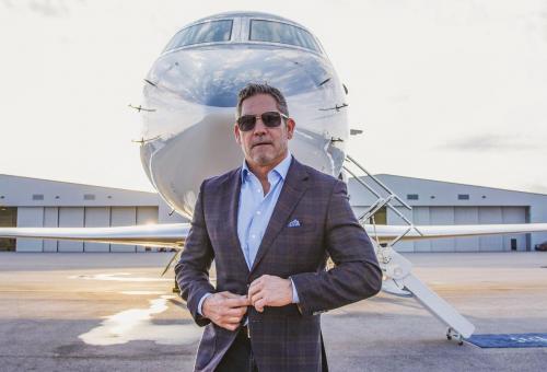 Grant Cardone on the runway in front of his private jet