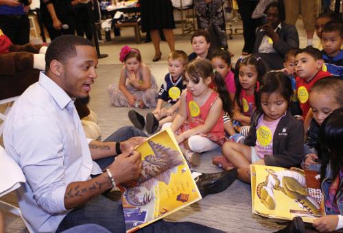 Patrick Chung, player for the New England Patriots, reads to children in Boston at the Macy’s store. Macy’s is a long-time sponsor of RIF.
