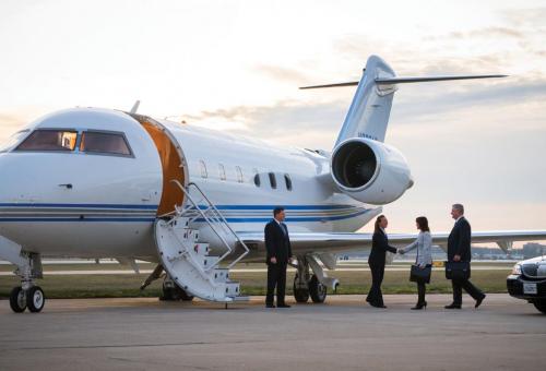 Private jet passengers boarding business jet