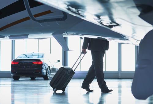 business jet and man with suitcase
