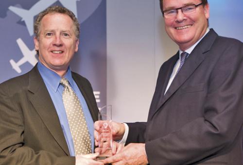 Robert Mark (left) receives his award in Paris from World leadership forum pr