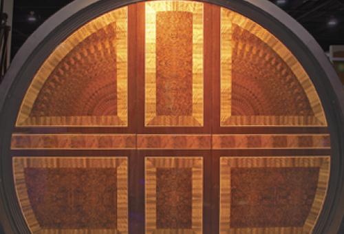 This hand-cut marquetry contains mahogany and walnut veneers and maple edging