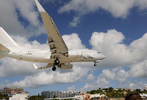 plane flying over beach