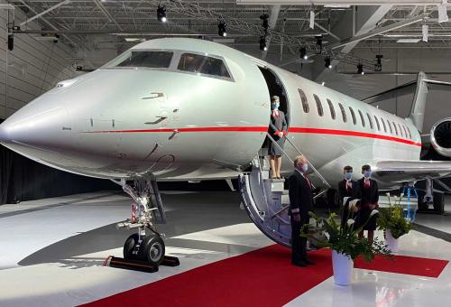 VistaJet Global 7500 on display, surrounded by red carpet and Bombardier employees at the 100th delivery ceremony