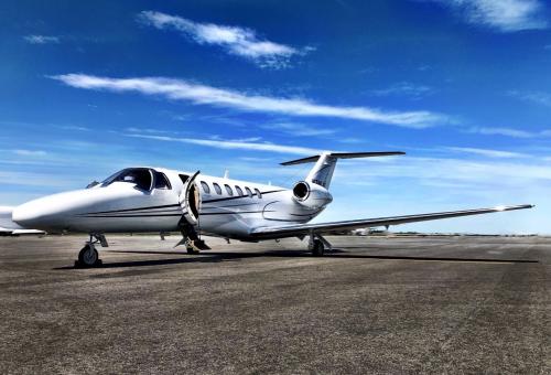 FlyExclusive CJ3 on the ramp with door open and stairs extended