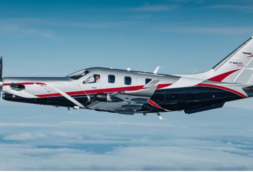 Daher TBM 960 with Sirocco paint scheme in silver and black with red accent stripes in flight