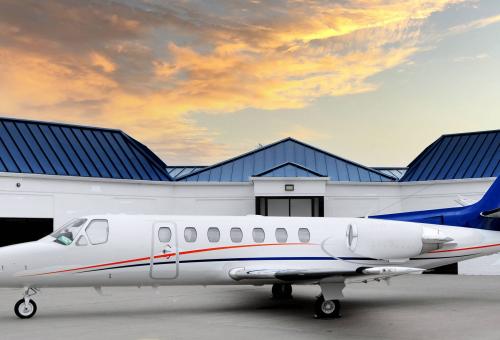 Premier Private Jets Cessna Citation Ultra parked on airport ramp by FBO
