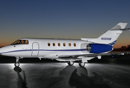 Hawker 800XP operated by Executive Airlink parked on airport ramp at sunset